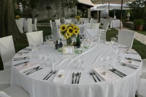 a table with glasses and a vase of flowers on it at Boutique B&B Stancija 1904 Adults only in Svetvinčenat