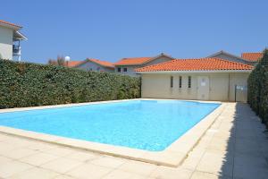 a swimming pool in the backyard of a house at Residence Oceanis in Biscarrosse-Plage