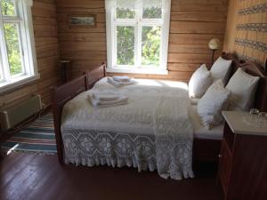 a bedroom with a bed with two towels on it at Storjord Hotel in Storjord