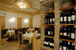 un restaurante con un montón de botellas de vino en Hotel Falzares, en San Cassiano