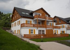 a large white house with a wooden fence at Apartment Am Gerkenstein 29-M, Winterberg-Neuastenberg in Winterberg