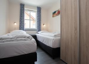 a bedroom with two beds and a window at Apartment Am Gerkenstein 29-M, Winterberg-Neuastenberg in Winterberg
