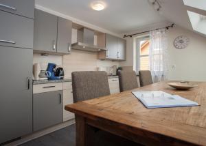 a kitchen with a wooden table and some chairs at Apartment Am Gerkenstein 29-M, Winterberg-Neuastenberg in Winterberg