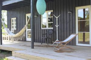 a porch with two hammocks and a house at Feriehus i Holtug in Holtug