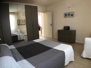 a bedroom with a bed and a dresser and a mirror at Casa Vacanze Vespucci in Torre del Lago Puccini