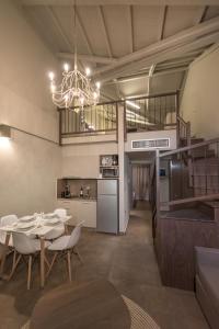 a dining room with a table and a chandelier at Armonia Lux Studios in Ierissos