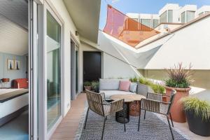 a patio with a table and chairs on a balcony at Room Mate Collection Giulia, Milan in Milan