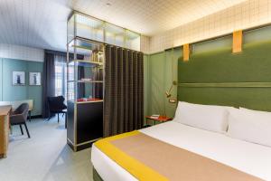 A bed or beds in a room at Room Mate Collection Giulia, Milan