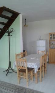 a kitchen with a table and chairs and a refrigerator at Agalina Sea House in Sozopol