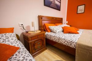 a bedroom with two twin beds and a night stand at Phiros B&B in Piran