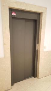 a large gray garage door with a sign on it at Apartamentos Plaza,viviendas turisticas in Alicante