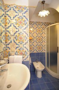 La salle de bains est pourvue d'une baignoire, d'un lavabo et de toilettes. dans l'établissement Locanda Degli Dei, à Praiano
