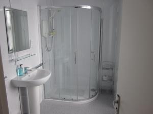 a bathroom with a shower, sink, and toilet at Station Hotel Portsoy in Portsoy