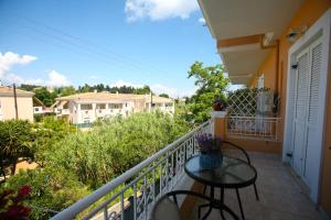 a balcony with a table and chairs on it at Tritsa House, 3-bedroom apt next to Corfu Town and airport in Corfu