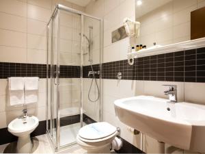 a bathroom with a toilet and a sink and a shower at Hotel Astoria in Bologna