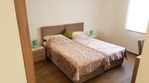 a bed in a bedroom with two night stands and two candles at Villas Simag in Banjole