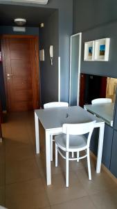 a white table and a white chair in a room at Fuerteventura in Loft in Gran Tarajal