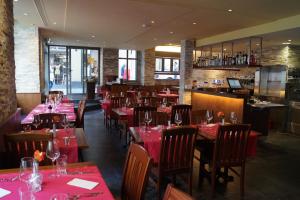 a restaurant with red tables and chairs and a bar at Hotel Old Town in Zurich