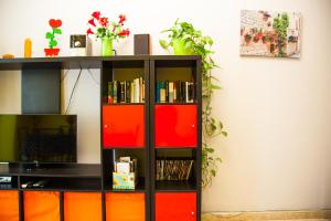 a black book shelf with orange and red drawers at Apartamento Rosellón in Barcelona