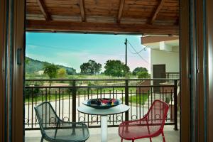 a table and chairs on a balcony with a view at Riviera Perdika Hotel in Perdika