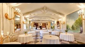 a room with white tables with flowers on them at Domaine de Rennebourg in Saint Denis Du Pin