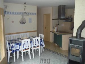 a kitchen with a table and chairs and a stove at Zum alten Seemann in Pruchten