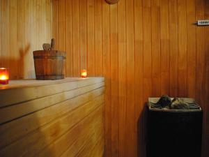 a room with a wooden wall with two candles and a bucket at Hotel Regal Pacific Santiago in Santiago +59 photos