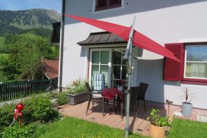 a red wind sock on a porch of a house at Haus Ortner in Russbach am Pass Gschütt