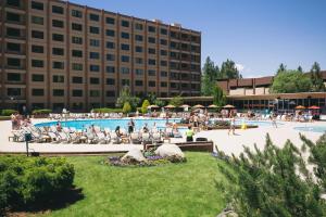 a hotel with a pool with people sitting in chairs at Golden Nugget Lake Tahoe in Stateline