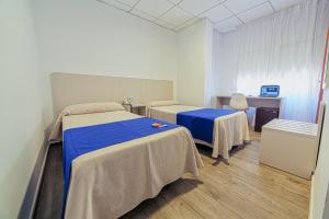 Postel nebo postele na pokoji v ubytování La Perla