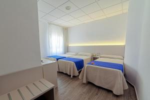 Postel nebo postele na pokoji v ubytování La Perla
