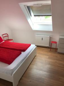 a bedroom with a bed with red sheets and a skylight at SWISS LOFT by Europa-Park - EP Ticket Garantie in Rust