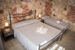 Postel nebo postele na pokoji v ubytování Rocca Pinta Guest House