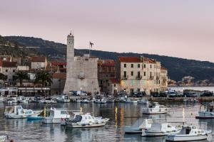 a group of boats are docked in a harbor at Apartment Riva 5 in Komiža