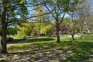 a park with trees and a person riding a bike at Apartament New Gdynia in Gdynia