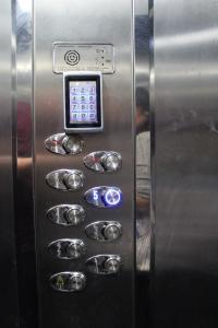 an elevator with a control panel in an elevator at Port Side Sarande in Sarandë