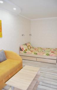 キーウにあるApartment on Bogdana Gavrilishyna 5のベッド2台とソファが備わる客室です。