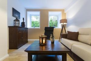 a living room with a couch and a table at Berlin City Apartments in Berlin