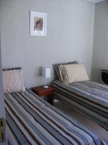 a hotel room with two beds and a table at Anvers in Ostende