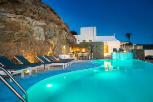 a pool with chaise lounge chairs and a resort at Mykonos Beach Hotel in Mikonos +54 photos