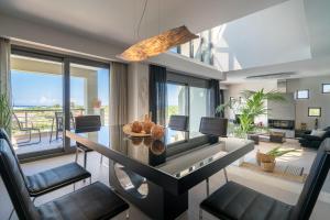 a living room with a dining table and chairs at Akemi Luxury Villa in Tsilivi