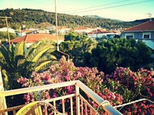 a balcony with a view of flowers and houses at Foteini Rooms in Skala Sotiros