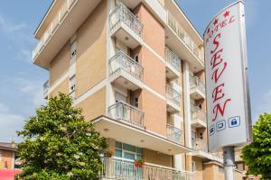 a building with a sign in front of it at Hotel Seven in Rimini