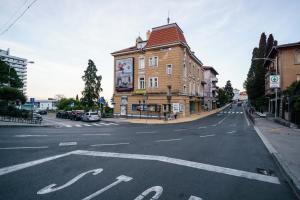 an empty street with a building on the side of the road at Apartments Lanča in Opatija