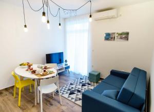 a living room with a blue couch and a table at Apartments Lanča in Opatija +33 photos
