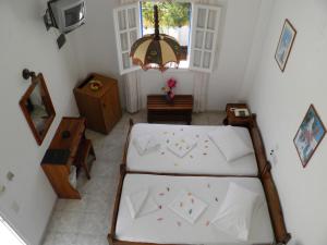 a bedroom with a bed and a television and a window at Levante Beach Hotel in Kamari