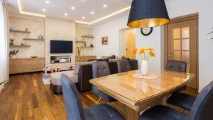 a dining room and living room with a table and chairs at Luxury Apartment Luce in Split