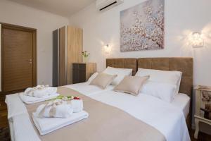 a bedroom with two beds with towels on them at Luxury Apartment Luce in Split