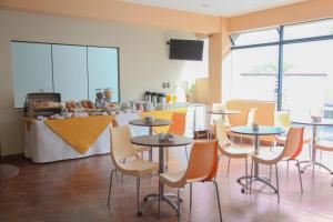 a restaurant with tables and chairs and a counter at Hotel Rivera Inn in Lima