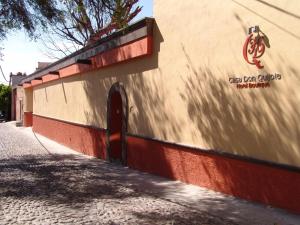 a wall of a building with a shadow on it at Hotel Casa Don Quijote in San Miguel de Allende